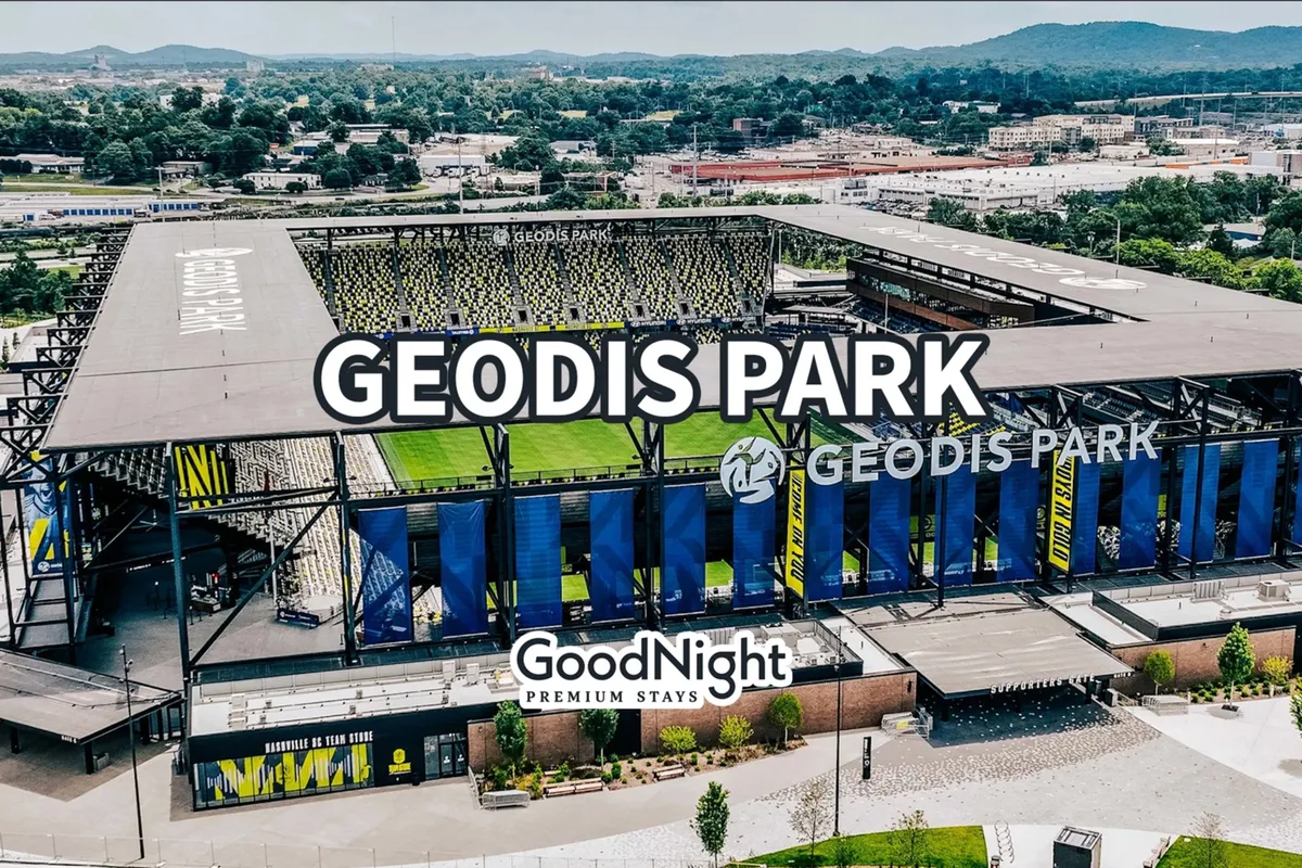 This image captures Geodis Park stadium against a lively city backdrop, with the GoodNight Premium Stays logo visible and the surrounding landscape suggesting a bustling urban environment. The scene conveys the excitement and energy of attending a major sports event or concert, with ample space for group gatherings and special occasions.